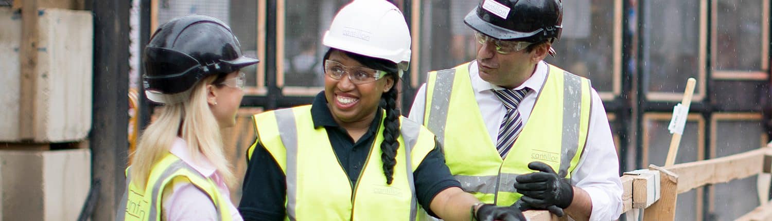 Two women on construction site with male colleague