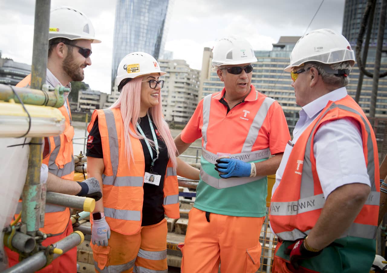 Woman construction worker with male colleagues on Tideway site